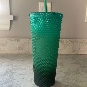 Green Starbucks tumbler.